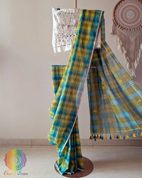 Green and yellow Madras checks Bengal cotton saree laid open displaying Jamdani palla and overall design