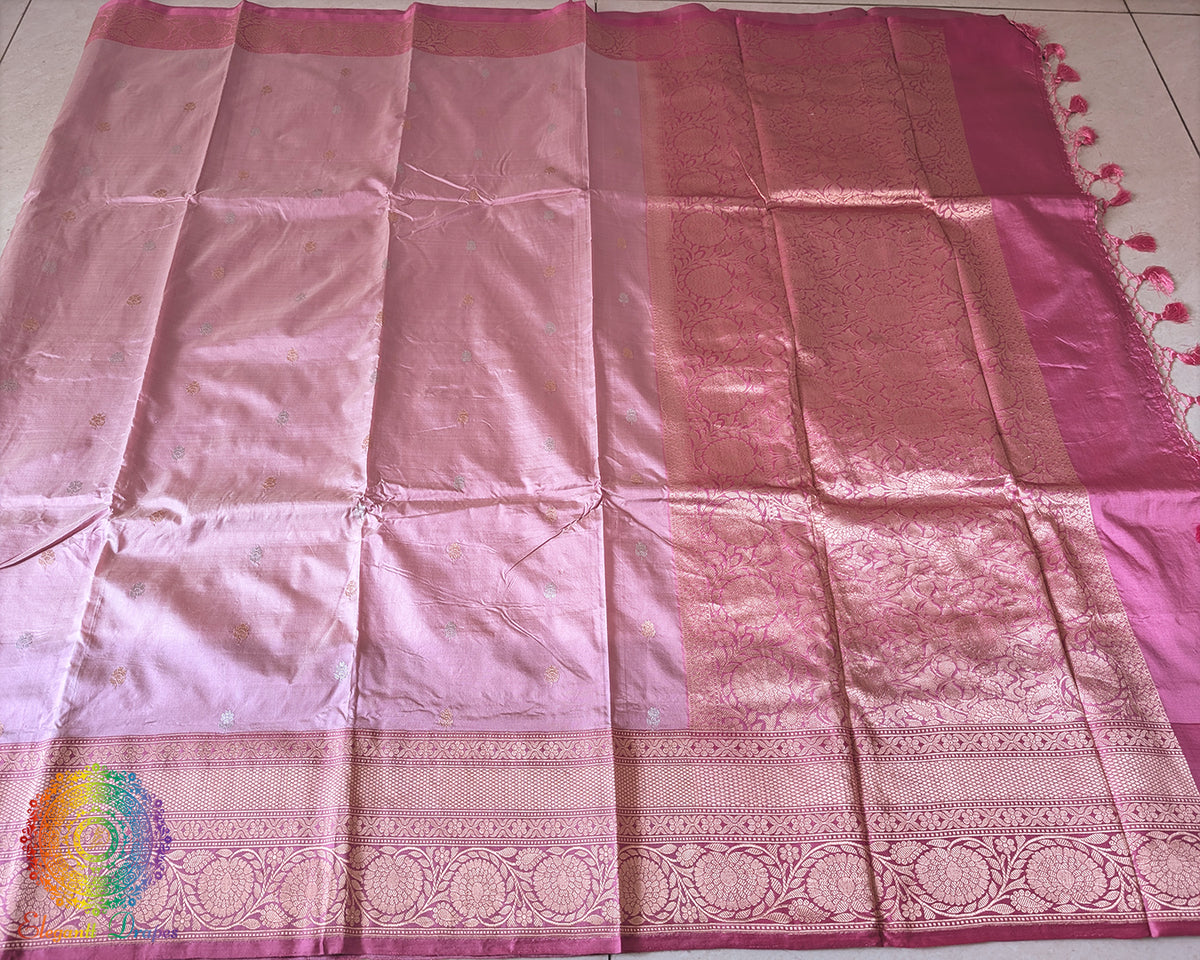 Full blush pink Banarasi Katan silk saree laid open showing overall woven design