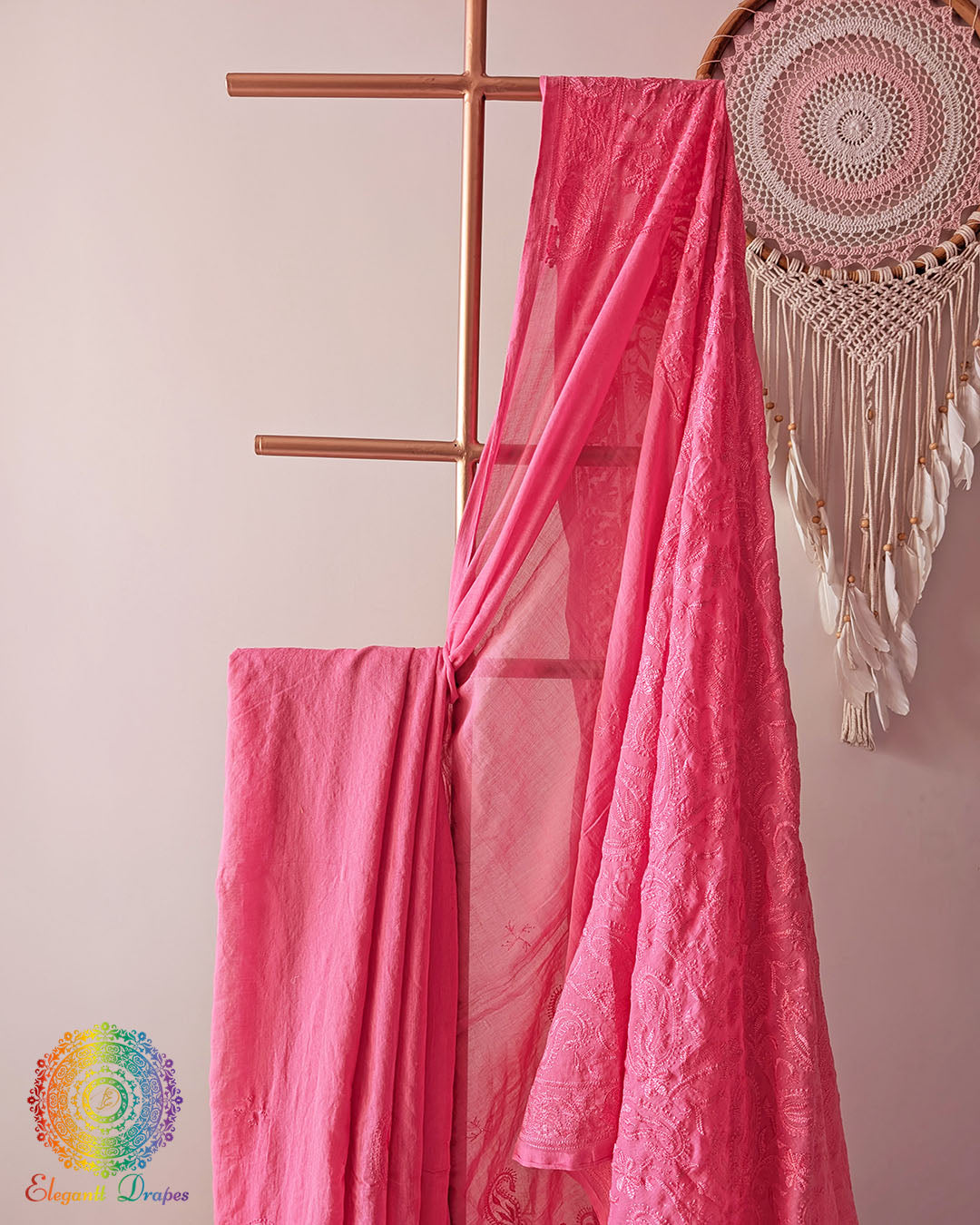 Blush pink cotton saree showcasing intricate paisley threadwork motifs