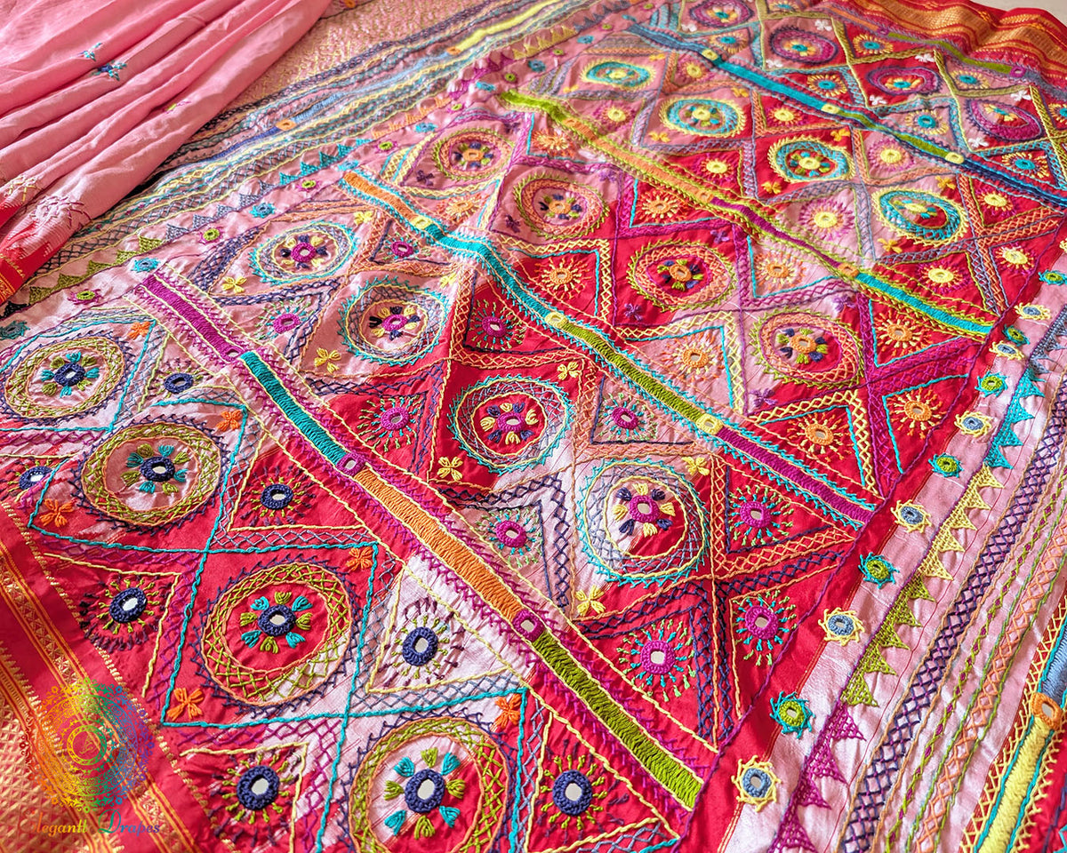 Detailed view of traditional Lambani hand embroidery on blush pink silk saree