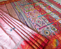 Close up of embroidered border and palla on blush pink Lambani saree