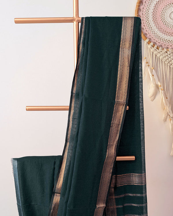 Bottle green Bengal cotton saree body close up highlighting fabric texture with zari border detail