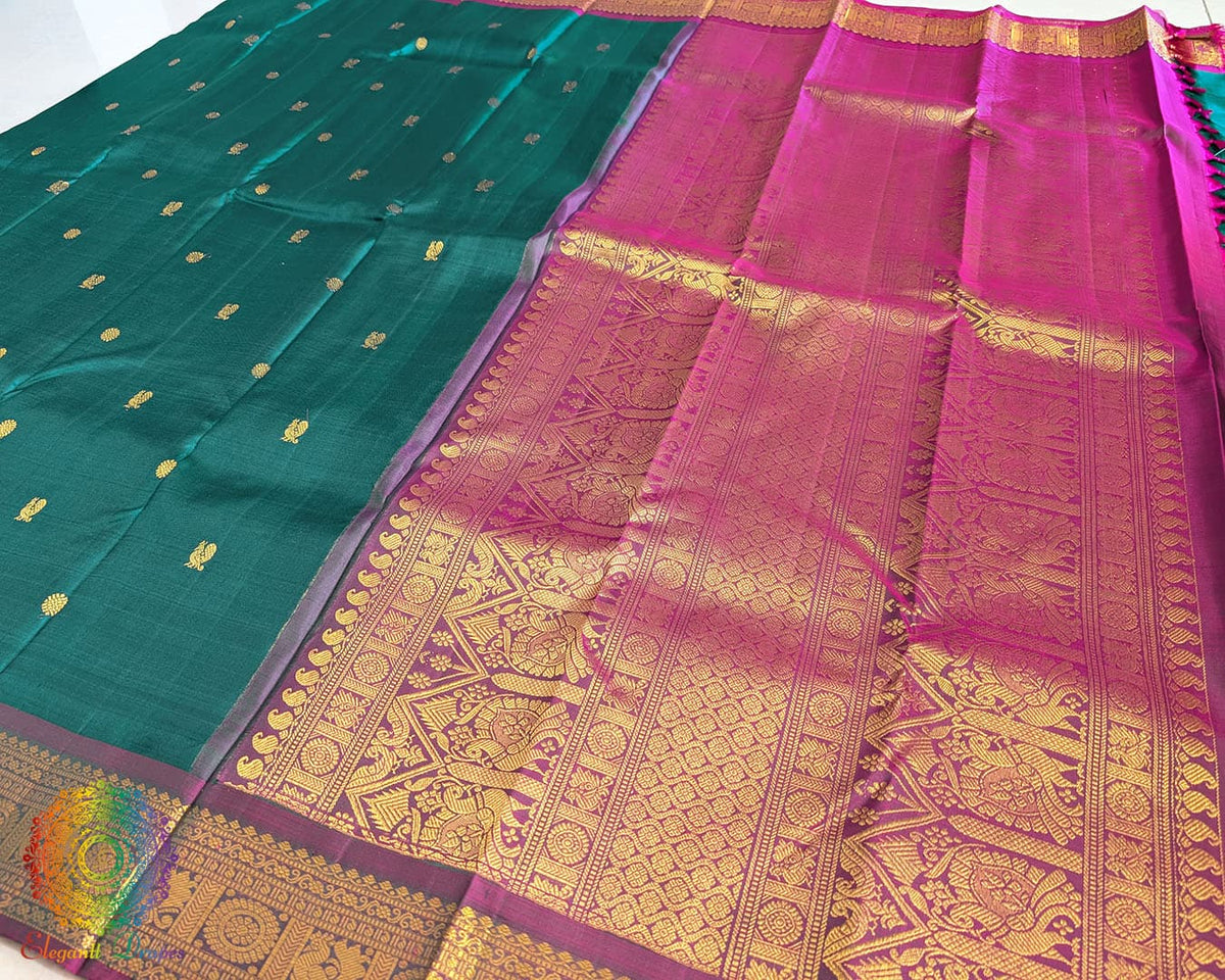 Bottle green Kanjivaram silk saree pallu view with traditional zari work