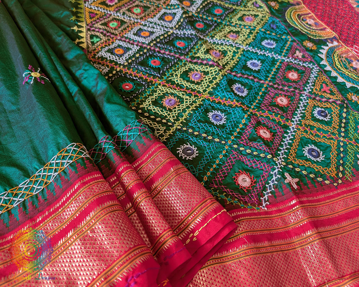 Intricate Lambani hand embroidery detail on bottle green silk saree