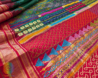 Deep Green Pure Ilkal Silk Saree with a detailed view of the red palla, featuring colourful Sindur Lambani hand embroidery and traditional handcrafted patterns.