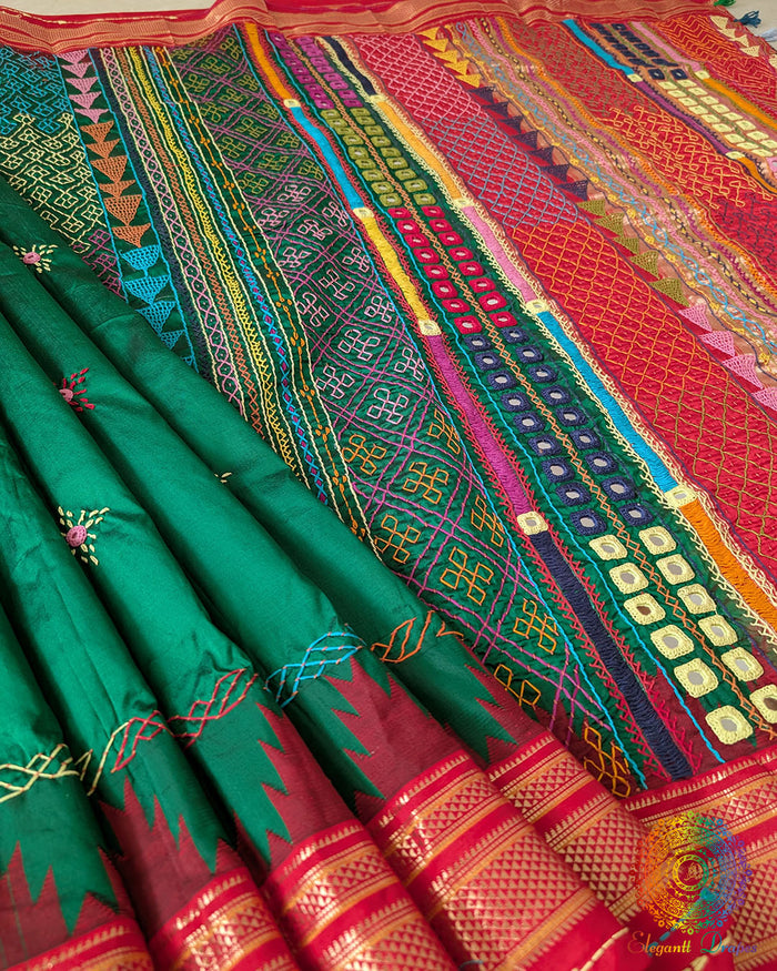 Deep Green Pure Ilkal Silk Saree with Sindur Lambani Handwork shown in a full draped view, highlighting the deep green body with a contrasting red palla and border.