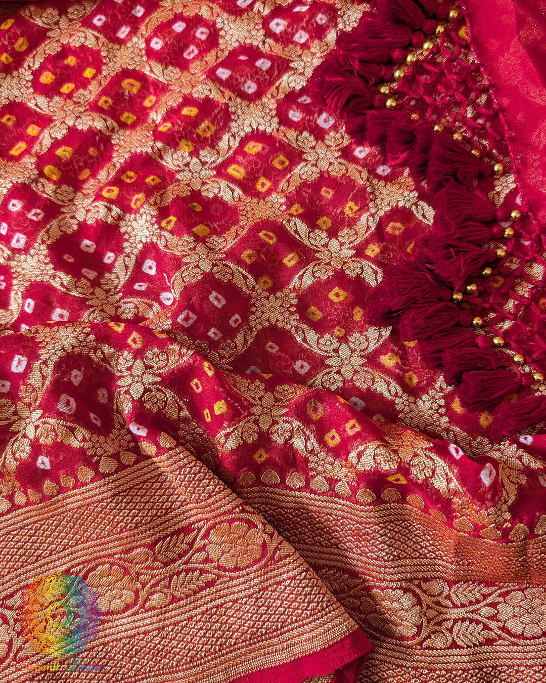 Close up of traditional Bandhani motifs on the bridal red Khaddi georgette Banarasi saree