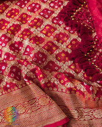 Close up of traditional Bandhani motifs on the bridal red Khaddi georgette Banarasi saree