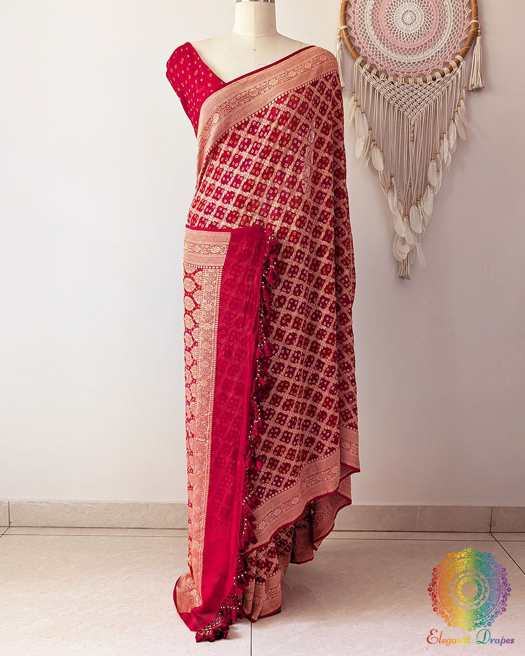 Bridal red Khaddi georgette Banarasi Bandhani saree on mannequin showing full drape and handcrafted heavy tassels