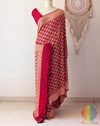 Bridal red Khaddi georgette Banarasi Bandhani saree on mannequin showing full drape and handcrafted heavy tassels