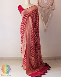 Bridal red Khaddi georgette Banarasi Bandhani saree highlighting the Banarasi woven palla and handcrafted heavy tassels