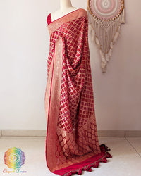 Side view of bridal red Khaddi georgette Banarasi Bandhani saree showcasing elegant drape