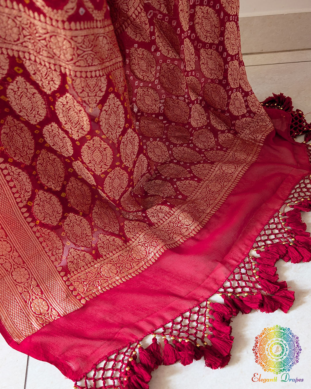 Close up of the Banarasi woven palla with handcrafted heavy tassels on the bridal red Khaddi georgette saree