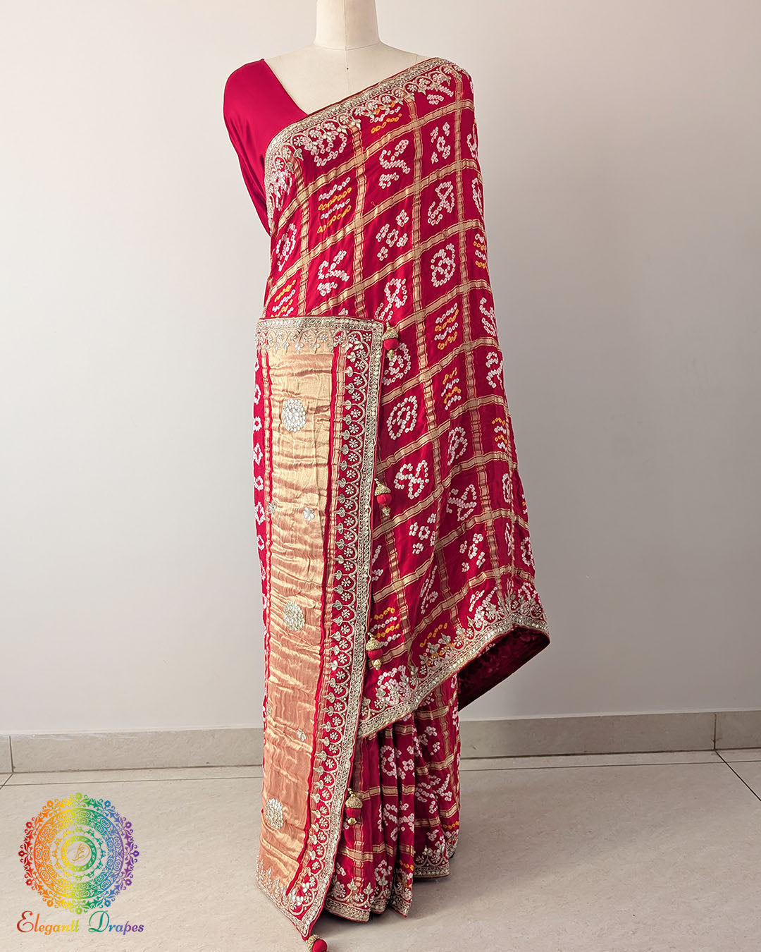 Bridal Red Gaji Silk Gharchola Saree with the palla visible in a draped view, displaying the traditional Gharchola patterns and decorative golden Gota Patti work.