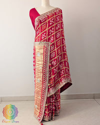 Bridal Red Gaji Silk Gharchola Saree with the palla visible in a draped view, displaying the traditional Gharchola patterns and decorative golden Gota Patti work.