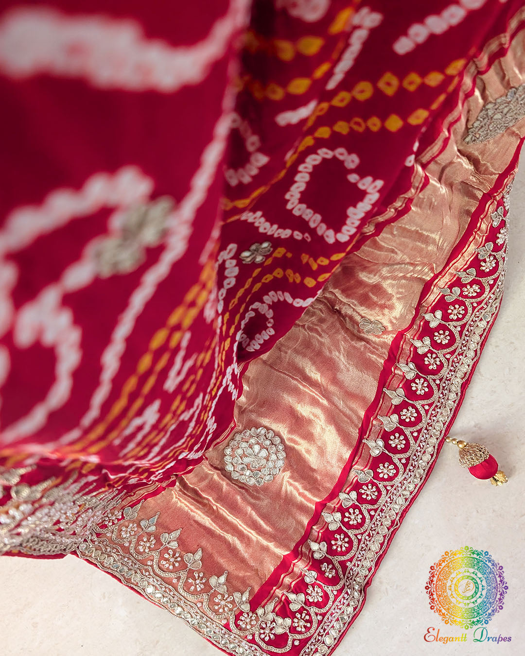 Close-up of the palla of the Bridal Red Gaji Silk Gharchola Saree, showcasing the intricate Gota Patti embellishments, traditional design details and rich silk texture.