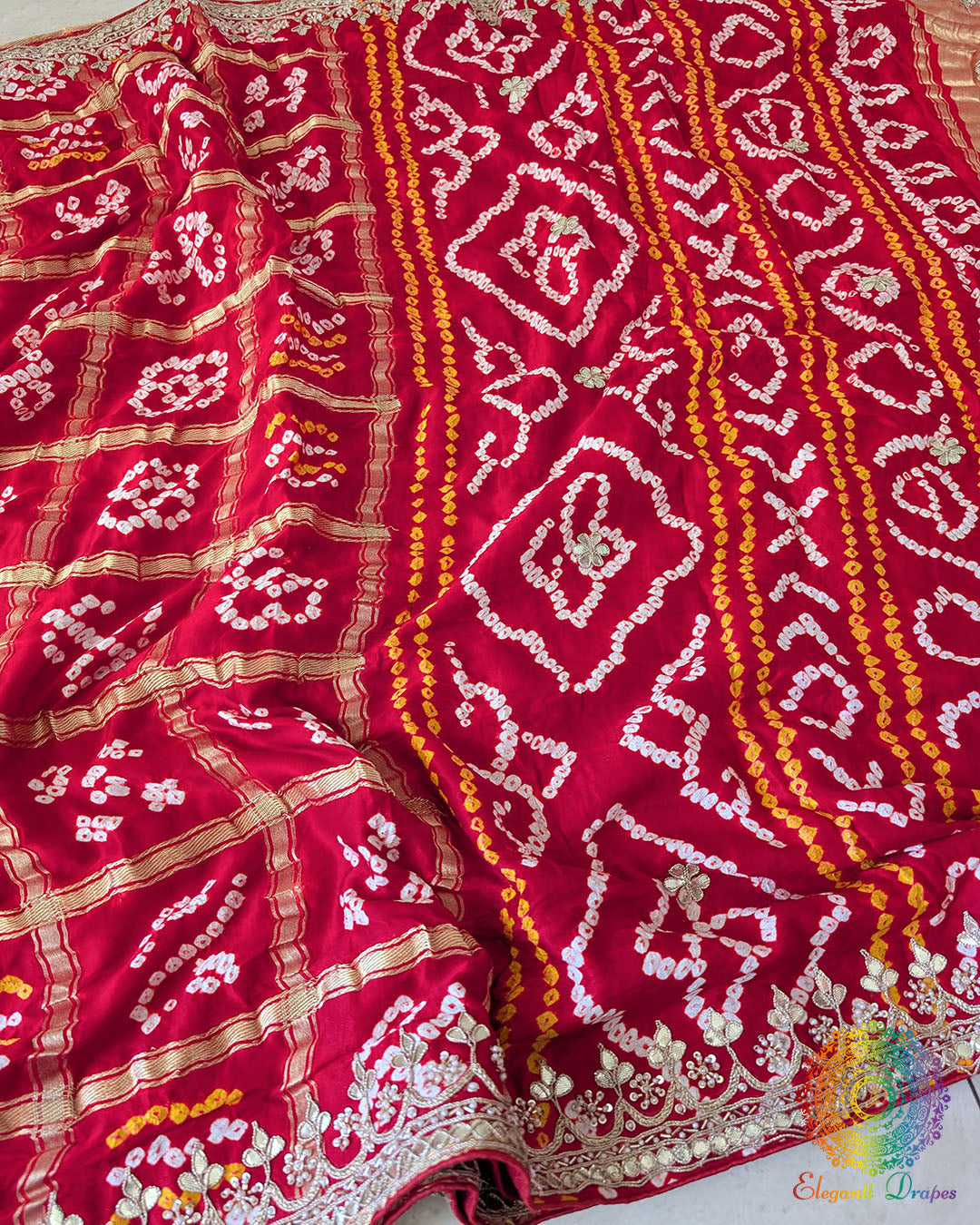 Bridal Red Gaji Silk Gharchola Saree displaying the traditional Gharchola patterns and decorative golden Gota Patti work.