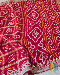 Bridal Red Gaji Silk Gharchola Saree displaying the traditional Gharchola patterns and decorative golden Gota Patti work.