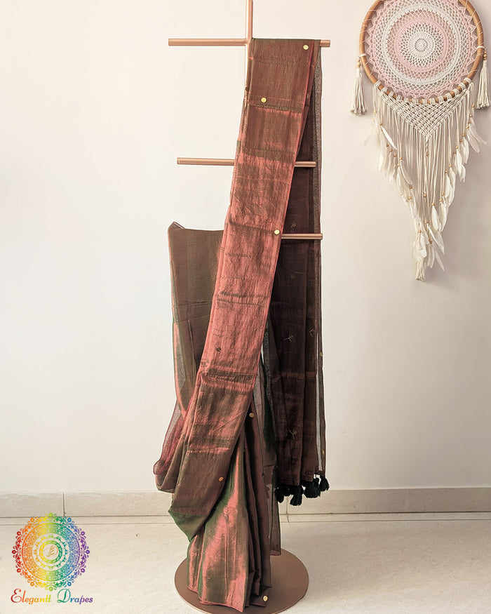 Brown Bengal mul tissue saree showing elegant drape and sequins work