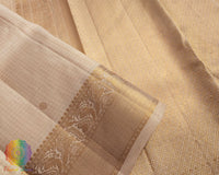 Close up of cream Kanjivaram silk saree showing check weave and zari detail