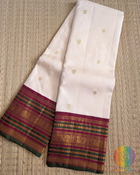 Off white pure Kanjivaram silk saree with green and deep red pallu 2 gram zari Elegantt Drapes