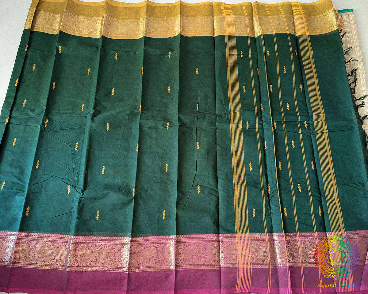 Full deep green Kanchi cotton saree laid flat highlighting dual tone border design
