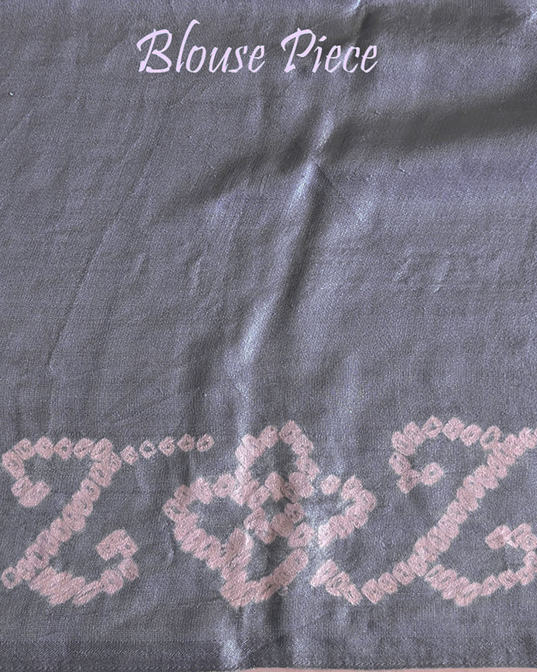 Matching blouse piece in deep grey Gharchola bandhani silk showing pattern