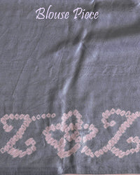 Matching blouse piece in deep grey Gharchola bandhani silk showing pattern