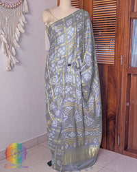 Deep grey Gharchola gaji silk bandhani saree on mannequin showing full drape