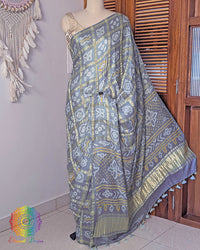 Palla view of deep grey bandhani saree on mannequin highlighting palla fall