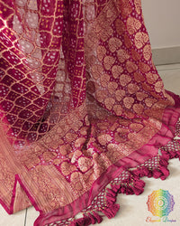 Close up of the Banarasi woven palla with heavy handcrafted tassels on the deep magenta Khaddi georgette saree