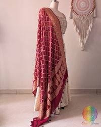 Side view of deep red Banarasi georgette Gharchola Bandhani dupatta showcasing elegant drape, Gharchola checks, and Bandhani motifs