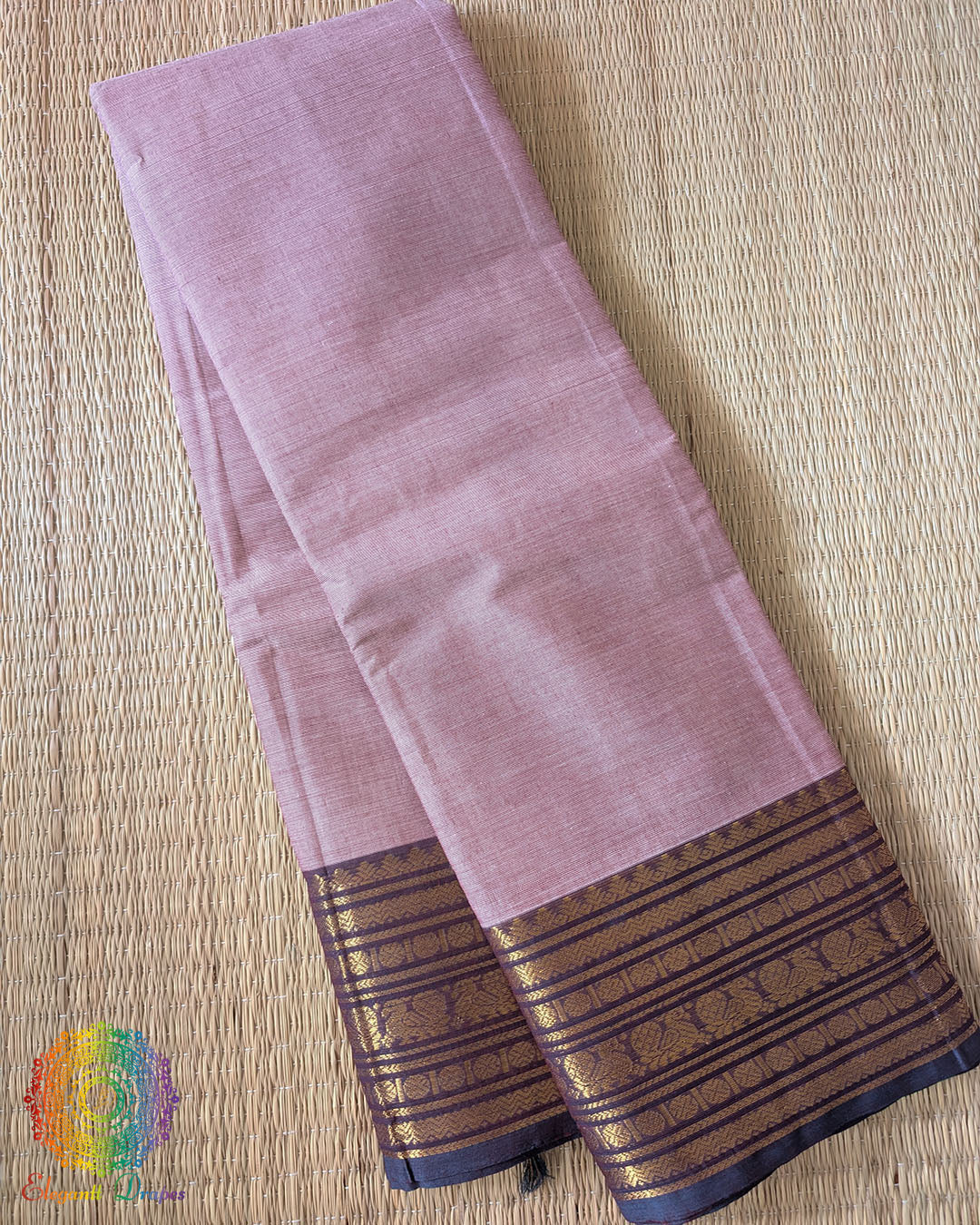 Folded dusty pink pure Kanchi cotton saree showing woven border detail