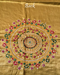 Close-up of large circular Bavadiya handwork motif on Golden Mustard Mashru Silk Blouse Piece back
