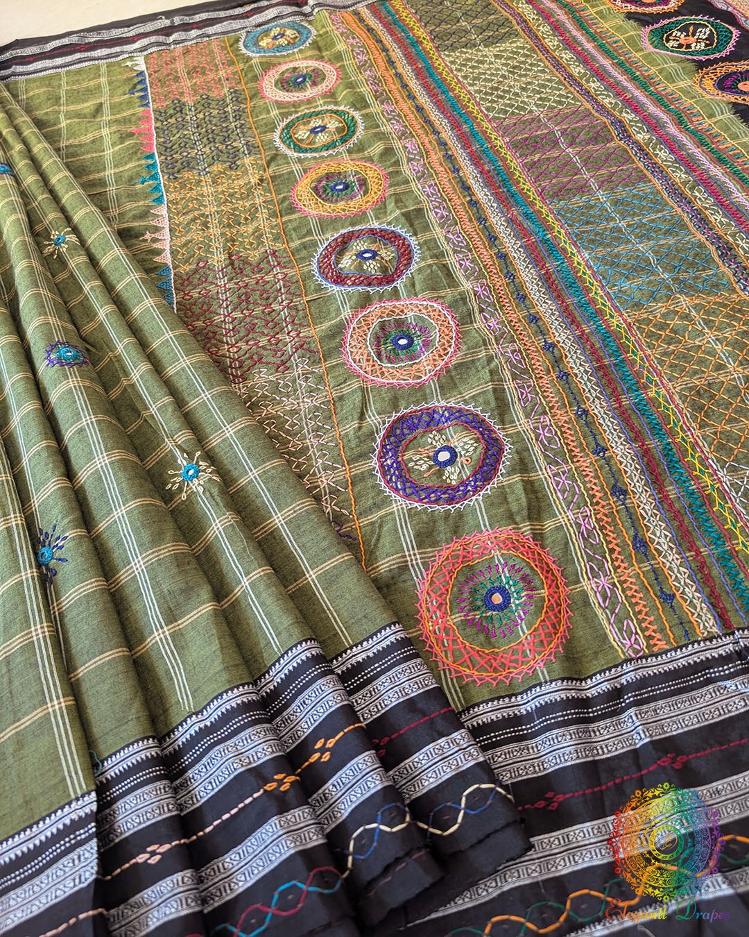 Green Ilkal cotton fabric showcasing woven texture and handcrafted Lambani embroidery