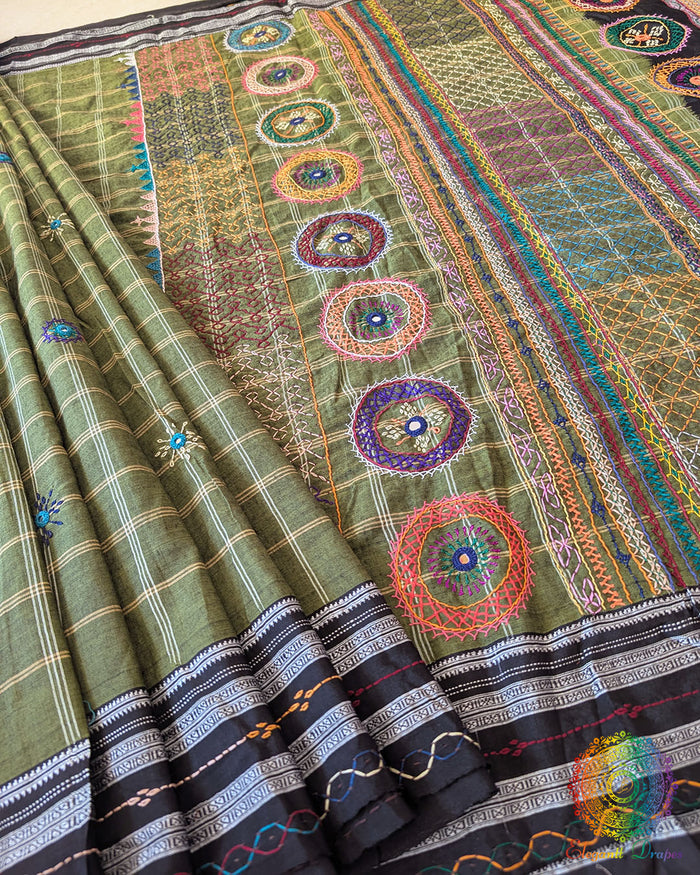 Green Ilkal cotton fabric showcasing woven texture and handcrafted Lambani embroidery