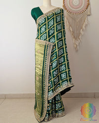 Side view of the Emerald Green Gaji Silk Gharchola Saree showcasing its graceful drape