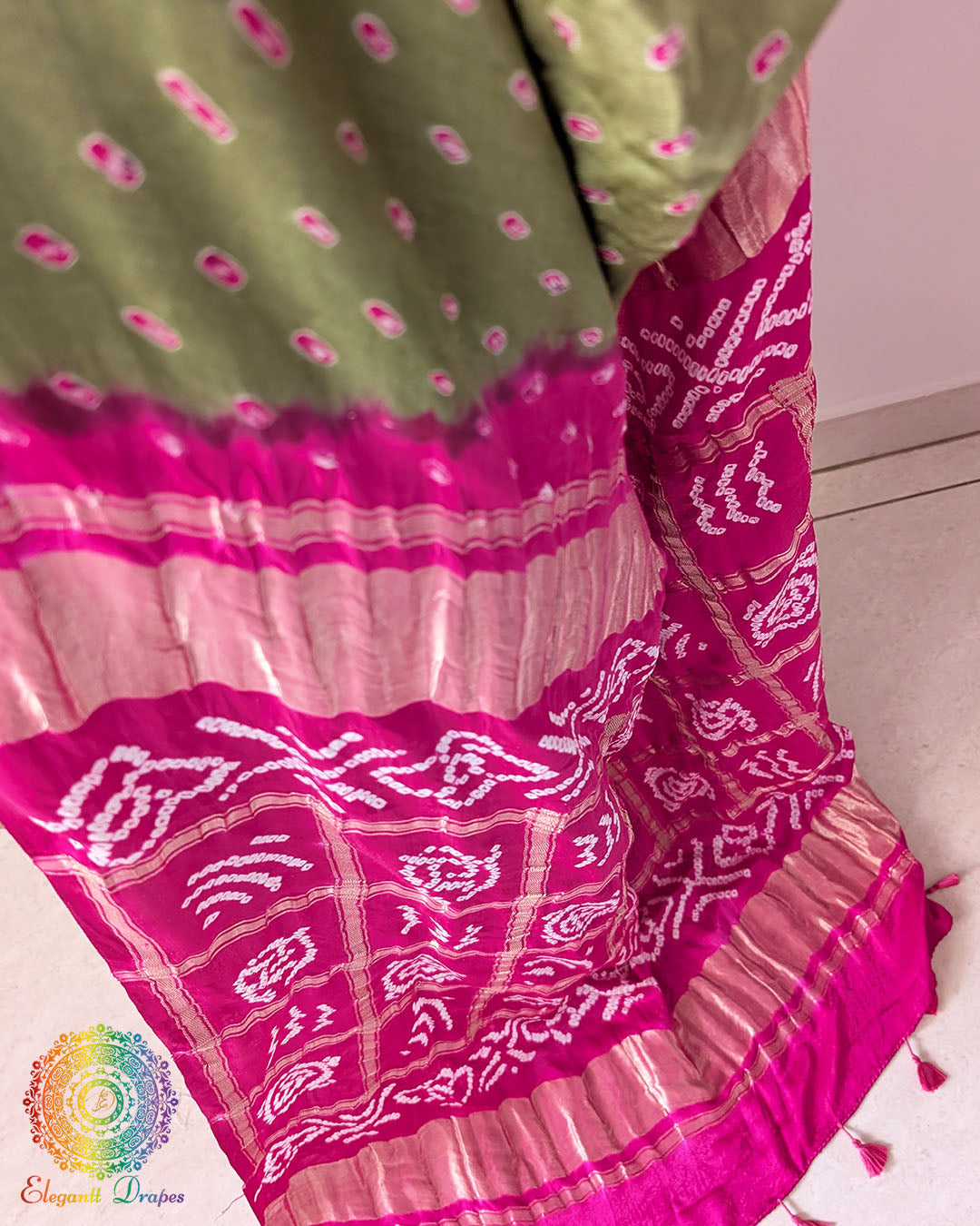 Close-up of Rani Pink Bandhani tie-dye motifs on the Sage Green Pure Gajji Silk Saree