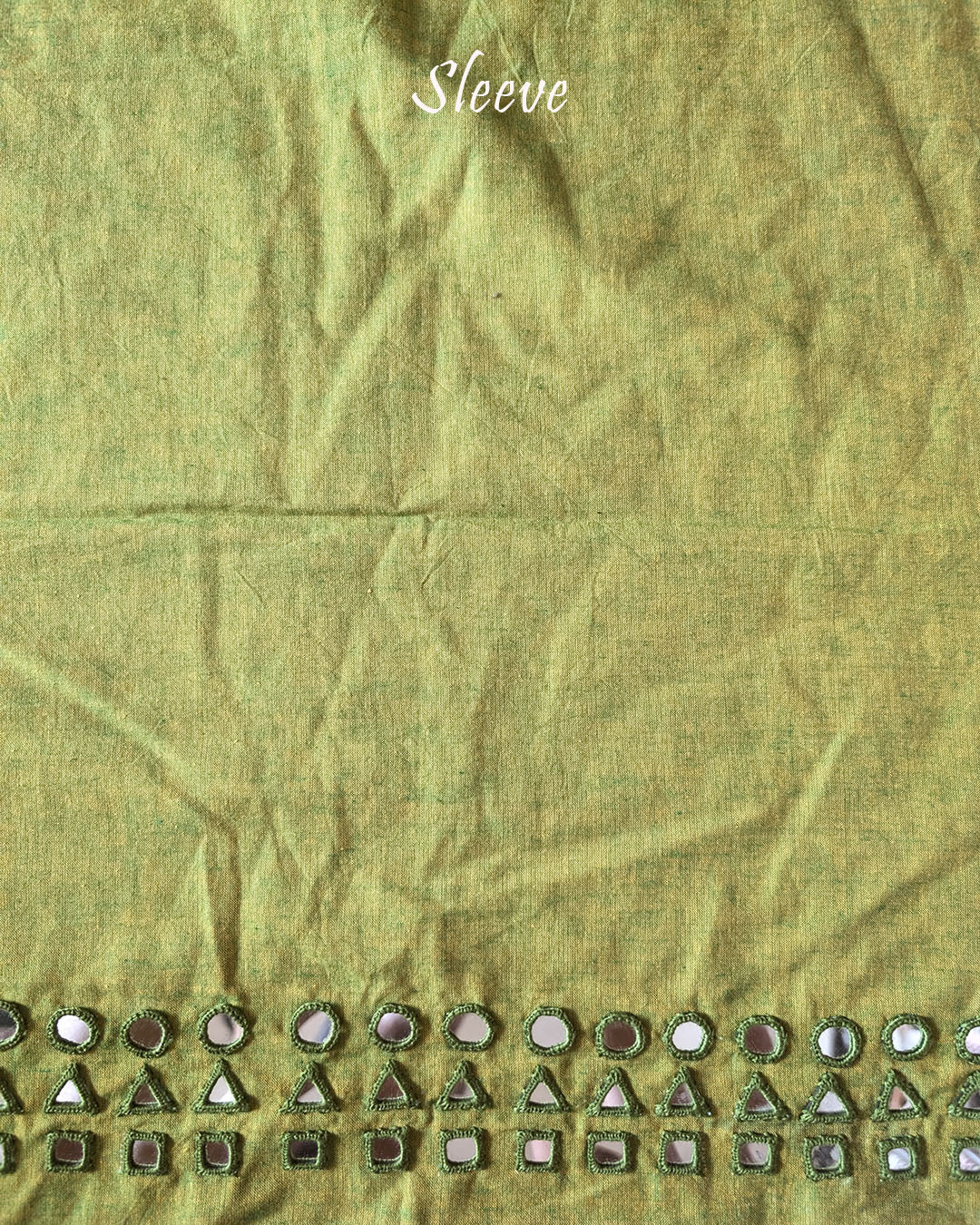 Sleeve detail of the Green Kala Cotton Kutch Mirror Handwork blouse piece, highlighting the mirror embellishments, decorative threadwork and rich green Kala Cotton fabric.