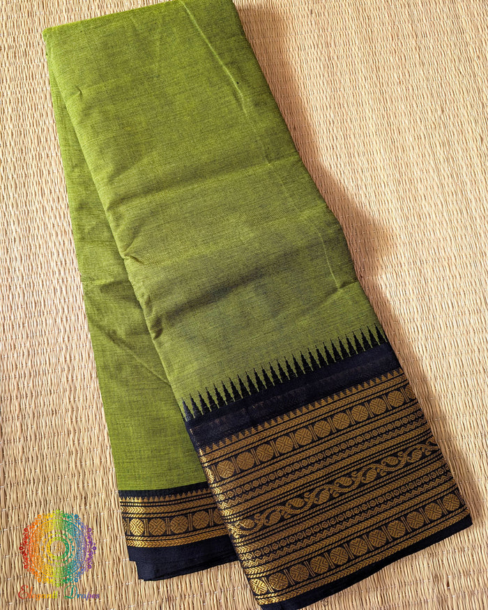 Folded mehandi green pure Kanchi cotton saree showing black border detail
