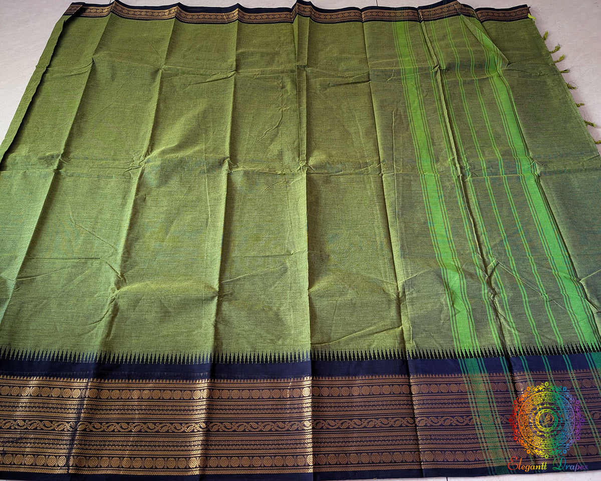 Full mehandi green Kanchi cotton saree laid open showcasing black border and overall design