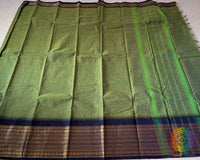 Full mehandi green Kanchi cotton saree laid open showcasing black border and overall design