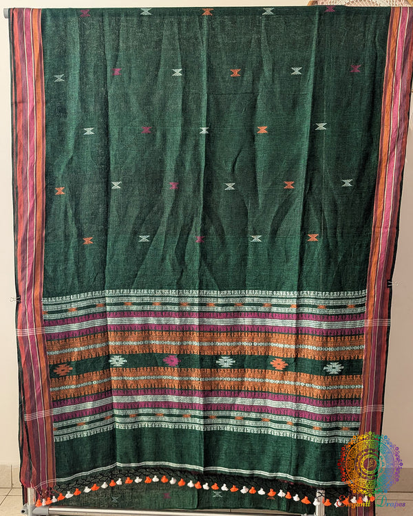 Full green linen saree laid open showing Bhujodi weave pattern and layout