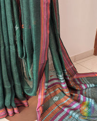 Pleats detail of green linen saree showing texture and structured drape