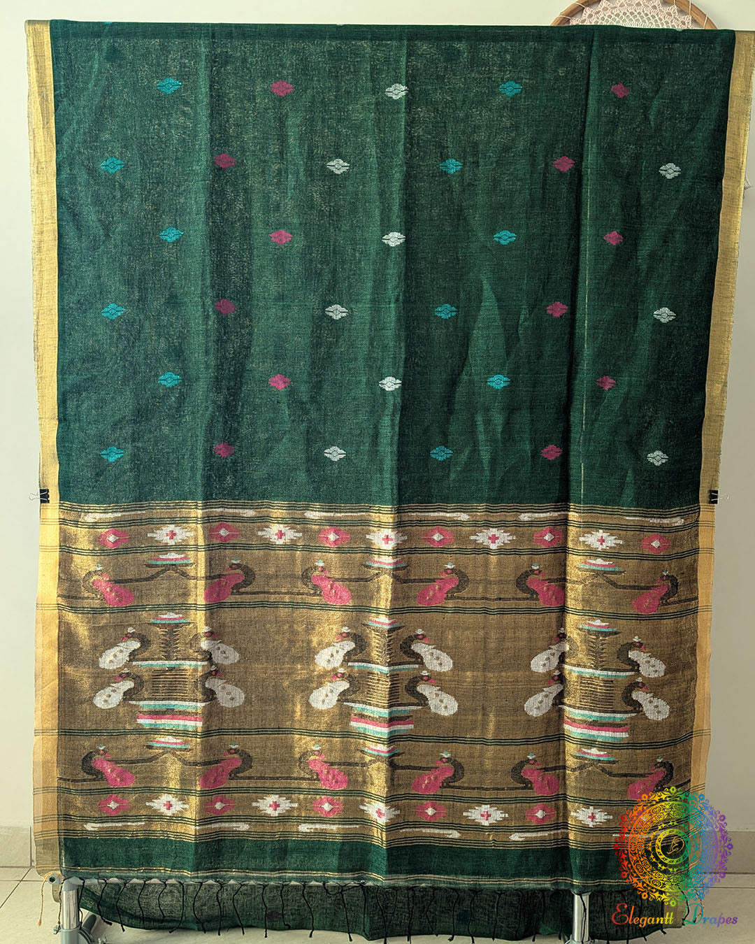 Full green linen saree laid open showing overall design and layout
