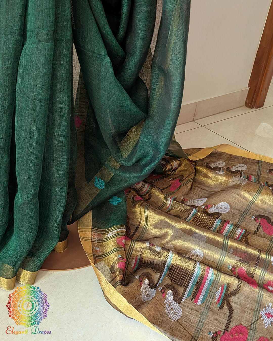 Pleats detail of green linen saree showing texture and structured drape