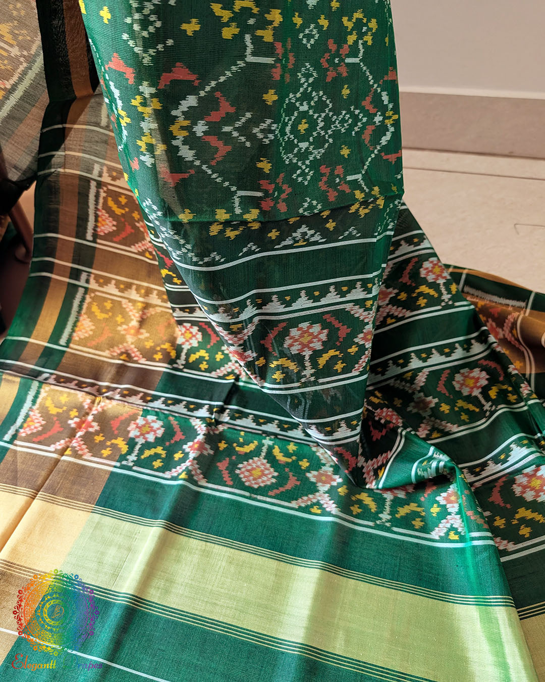 Green Rajkot Patola Silk Saree – Palla Close-Up highlighting the intricate traditional motifs and geometric patterns woven across the palla, showcasing the detailed craftsmanship and rich texture of the green mulberry silk.