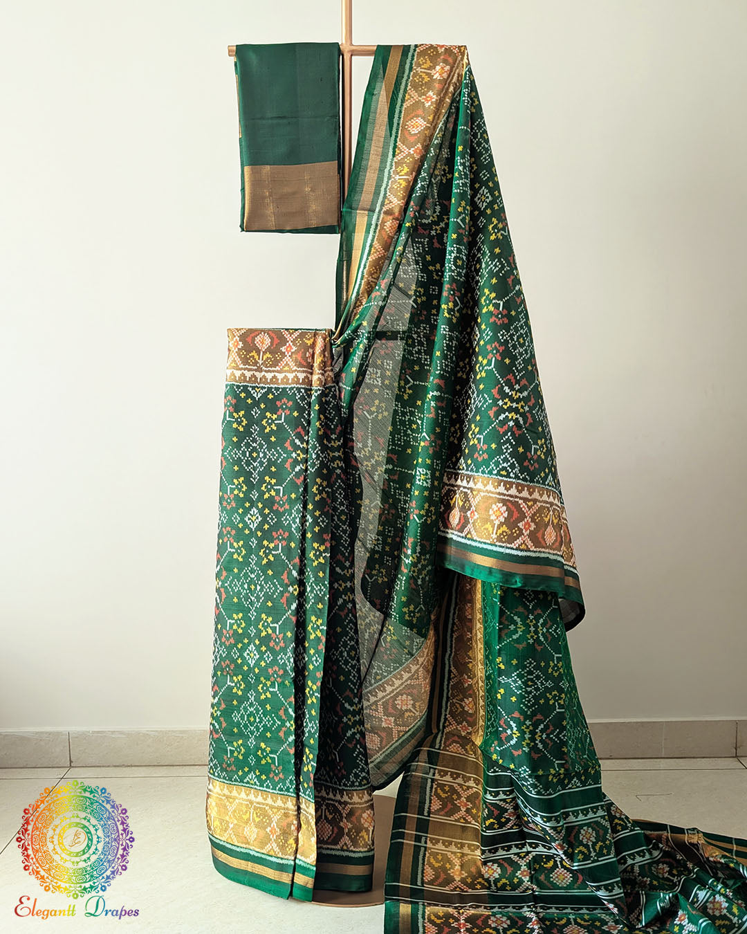 Green Handwoven Mulberry Silk Rajkot Patola Saree – Full Drape View showcasing the elegant green colour, traditional Rajkot Patola motifs and graceful drape of the handwoven mulberry silk saree, highlighting its rich silk texture and Gujarati textile heritage.