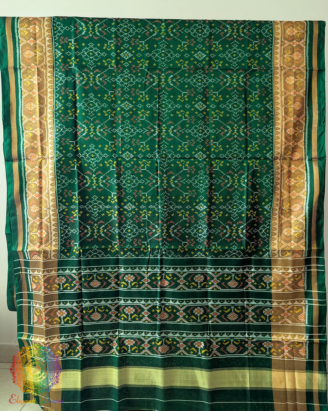 Green Handwoven Mulberry Silk Rajkot Patola Saree – Full Saree View displaying the complete saree with its green silk base and traditional Patola patterns, highlighting the intricate geometric designs and natural sheen of handwoven mulberry silk.