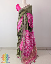 Green Pink Gaji Silk Rasmandaal Saree with Gota Patti Work in a front drape view, showcasing the contrasting green and pink colours, traditional Rasmandaal design and golden embellishments.